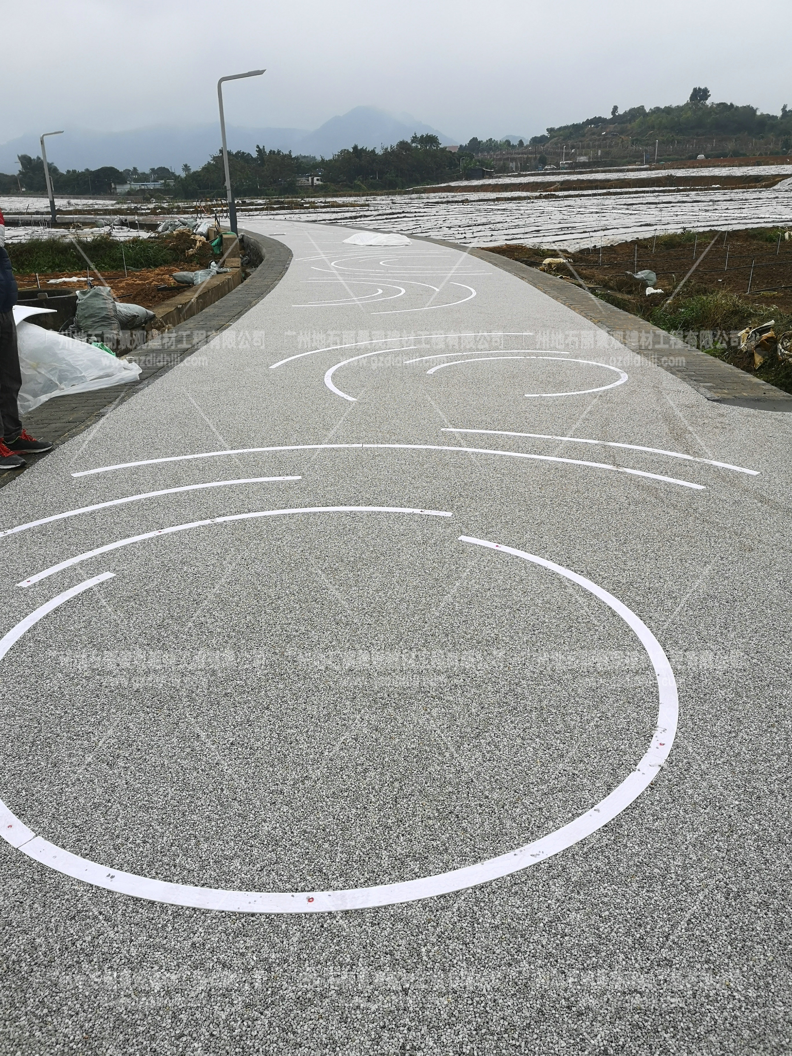 海綿城市透水發(fā)光石子膠粘石路面。深圳光明新區(qū)綠道支線段發(fā)光路面農田段